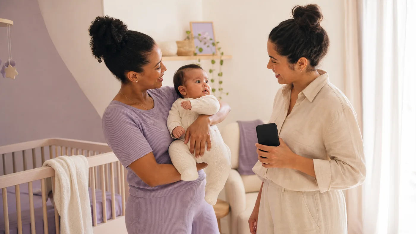 Two caregivers look after the baby together near the crib.